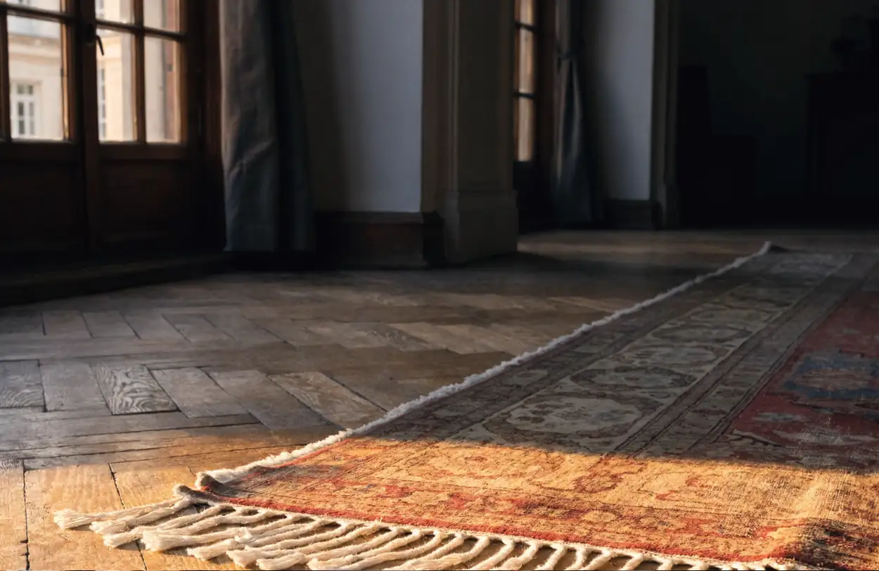 Coin d'un tapis persan ancien sur un parquet (illustration)